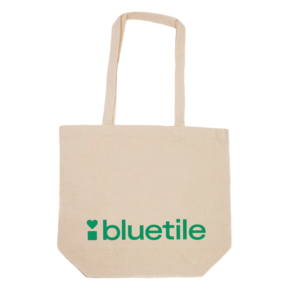 Canvas tote bag with Bluetile Skateboards BLUETILE GREEN LOGO TOTE printed on the side.