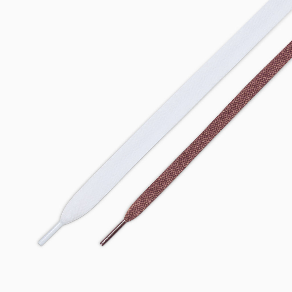 A pair of white and brown shoelaces on a white background, perfect for CONVERSE x QUARTER SNACKS ONE STAR PRO DARK CLOVE or skate shoes.