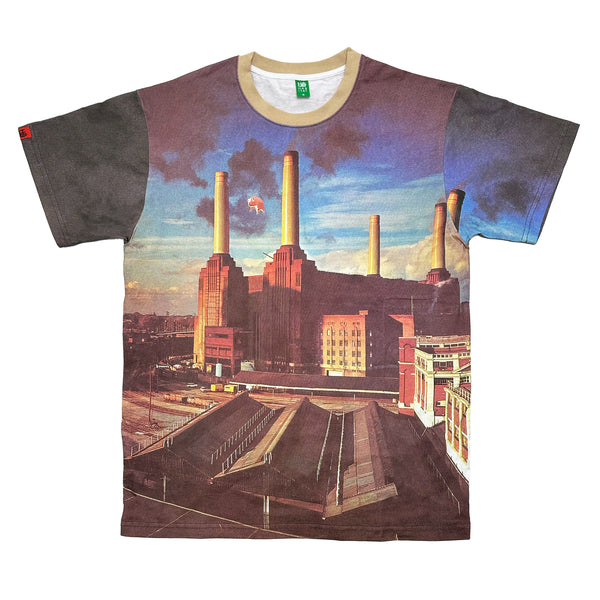 This HABITAT X PINK FLOYD ANIMALS TEE from HABITAT features an image reminiscent of Pink Floyd's iconic style, depicting a power station with four tall chimneys against a blue sky with clouds. A small section of the design even shows a floating pig near one chimney, bringing "Wish You Were Here" vibes to life.