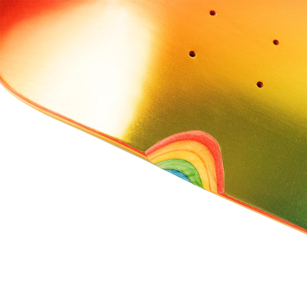 Close-up of the HARDBODY SABER RAINBOW skateboard deck by HARDBODY, featuring a metallic orange-gold finish and a small rainbow design near the edge.
