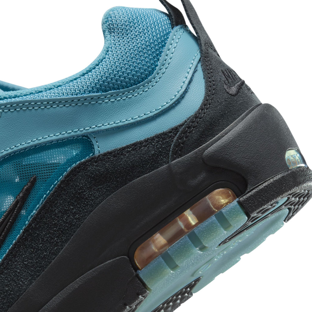 Close-up of the NIKE SB ISHOD 2 AIR MAX DENIM TURQ / BLACK sneaker by Nike, showcasing a turquoise and black design with a visible Air Max cushion in the sole.