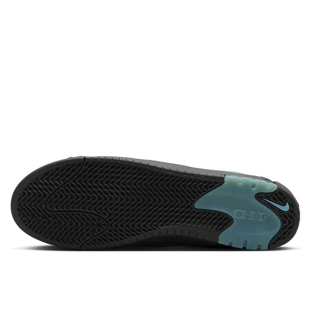 The image displays the sole of a black and teal Nike shoe with a wavy tread pattern and visible branding, similar to the NIKE SB ISHOD 2 AIR MAX DENIM TURQ / BLACK.