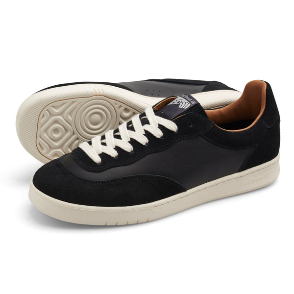 A Last Resort AB CM001 BLACK / WHITE sneaker with a white sole.