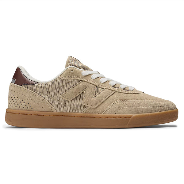The NB Numeric 440 V2 Incense/Rich Oak is a beige skate shoe featuring a white sole and matching laces, with a stylish brown heel accent, ideal for everyday skaters.