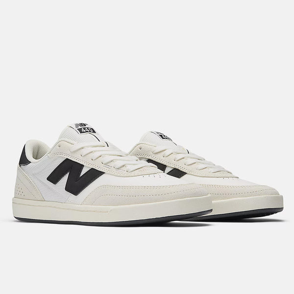 An off-white pair of NB Numeric 440 V2 Sea Salt / Black skate shoes with a black "N" logo, low-top design, and white laces is displayed on a plain white background.