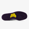 Sole of a shoe featuring a purple tread pattern with a central yellow emblem, displayed against a white background and integrated with NB NUMERIC foam.