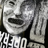 Close-up of a black and white textured artwork depicting a distressed face and fingers near cheek, partially obscured by blurred text on OPERA TWINS POP SLICK.