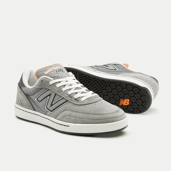 A pair of NB NUMERIC x VU 440 V2 GREY / ORANGE sneakers, displayed on a white background.