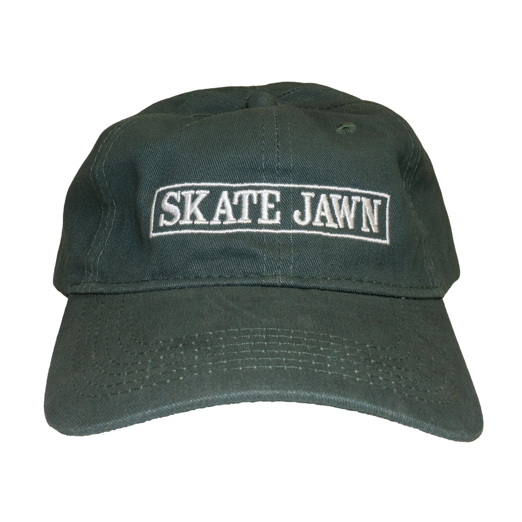 A SKATE JAWN 6-panel green hat with the word skate jawn on it.