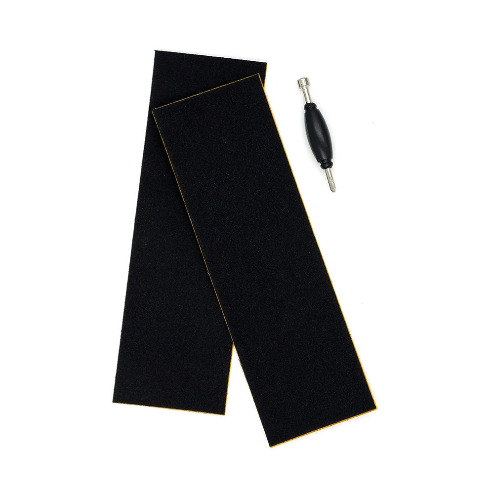 Two black rectangular grip tapes and a small tool for the SLUSHCULT "GROM" SERIES 009 FINGERBOARD HYDRANT, shown on a white background—ideal starter accessories for beginner fingerboarders.