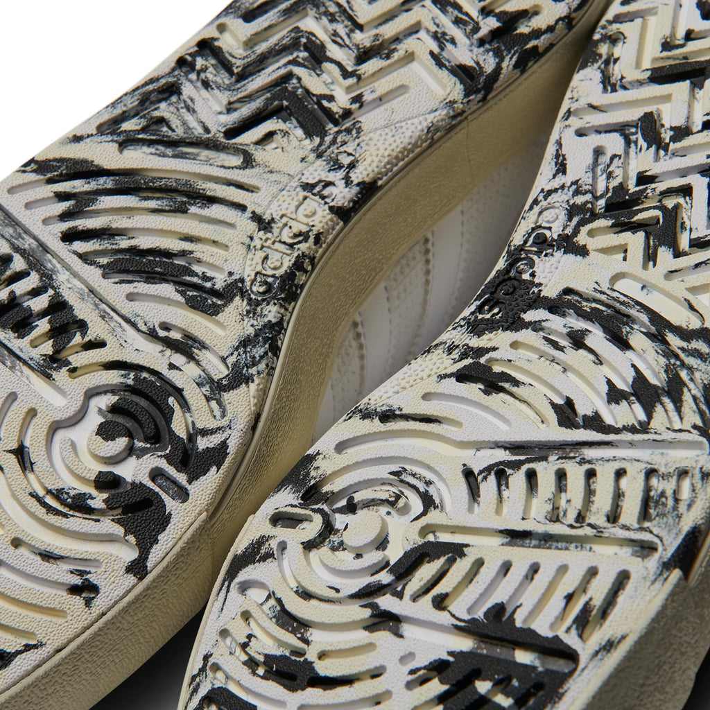 Close-up of ADIDAS NORA WHITE / WHITE / IVORY skateboard shoe soles with black and white design.