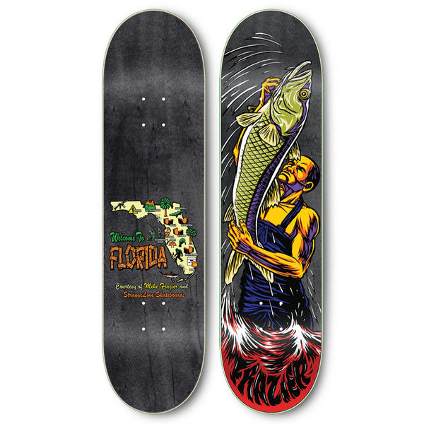 Two STRANGELOVE skateboard decks side by side; the left deck features a "welcome to Florida" sign with a beach, while the right deck, using Heat Transfer technology, displays a graphic of a mermaid holding