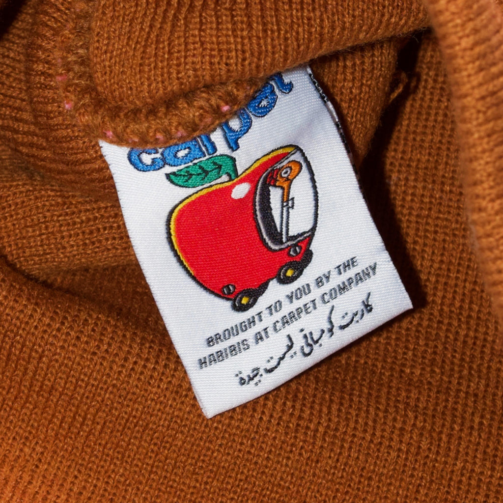 A close up of a Carpet Co. CARPET NO FOLD BEANIE BROWN with a label on it.