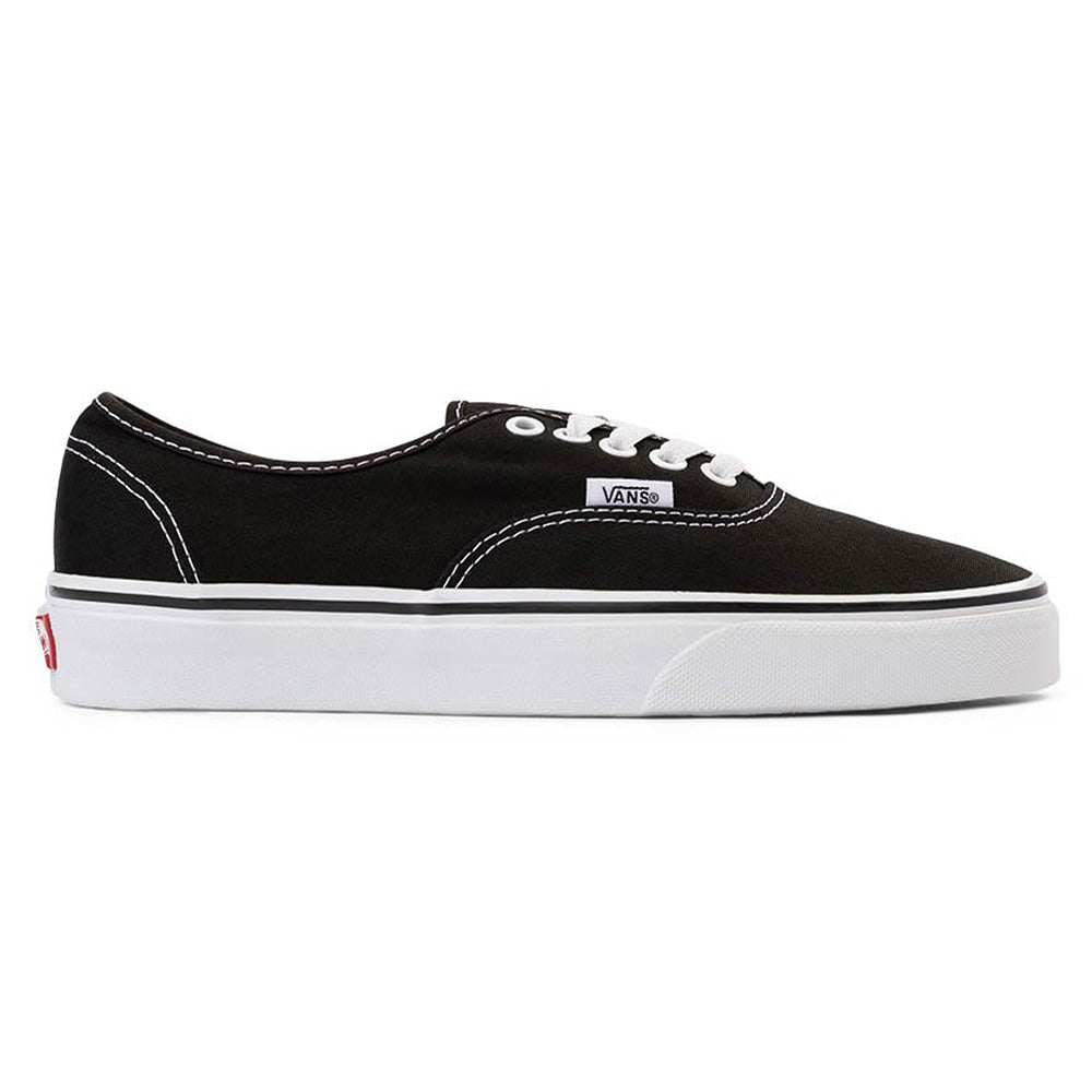 The VANS Authentic Black/White is a classic low-top sneaker with white stitching, a rubber waffle outsole, and a side Vans logo. Shown in profile on a white background.
