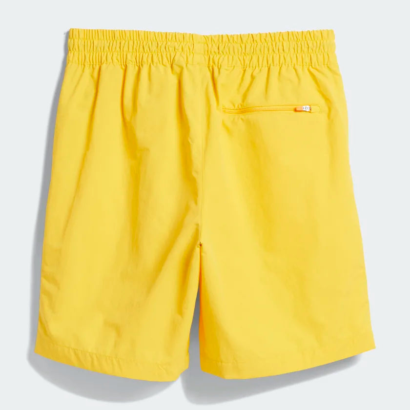 ADIDAS WATER SHORT BOLD GOLD/CREAM WHITE by ADIDAS features a gender-neutral design with an elastic waistband and small zippered back pocket. Shown against a light gray background.
