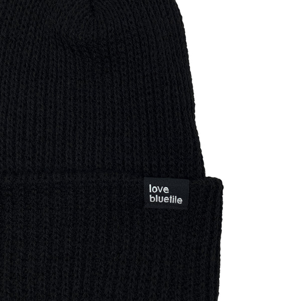 A BLUETILE LOVE ALWAYS KNIT BEANIE BLACK with the word love on it.