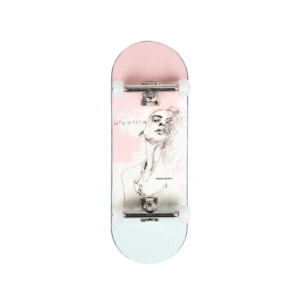 A Bluetile Skateboards fingerboard with a drawing of a woman on it.