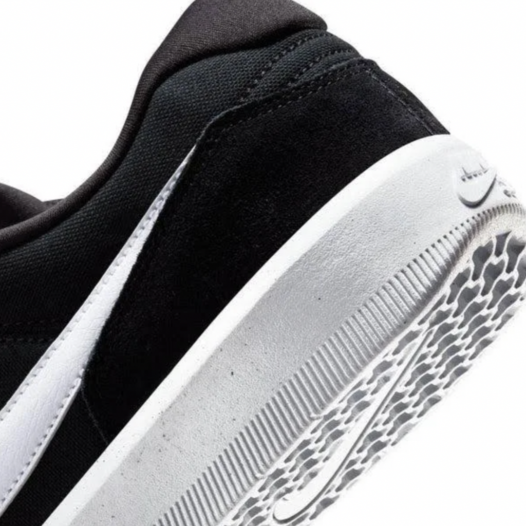 Close-up of the NIKE SB FORCE 58 BLACK/WHITE sneaker by Nike, highlighting the heel and textured sole ideal for skateboarding.