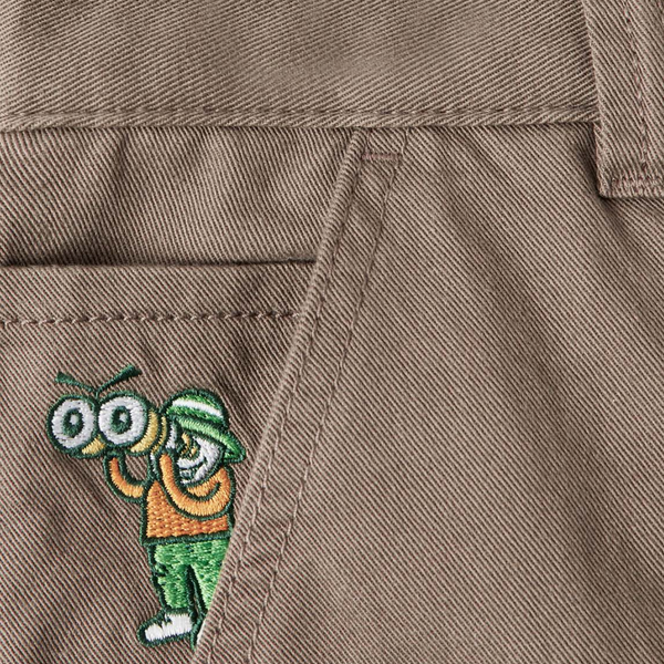 A close up of a person's POLAR '93! CARGO KHAKI pants with a cartoon character on it.