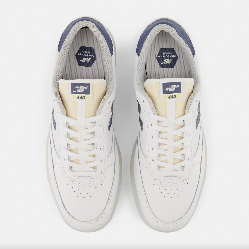 A pair of NB NUMERIC 440 white and blue sneakers on a white background.