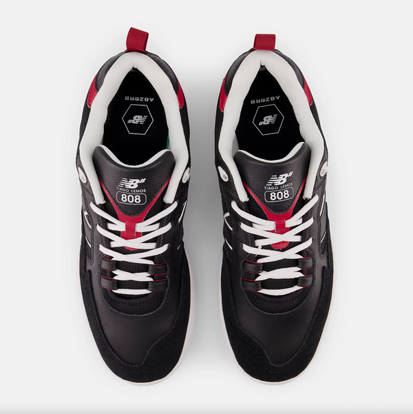A pair of NB NUMERIC 808 TIAGO BLACK / RED sneakers on a white background.