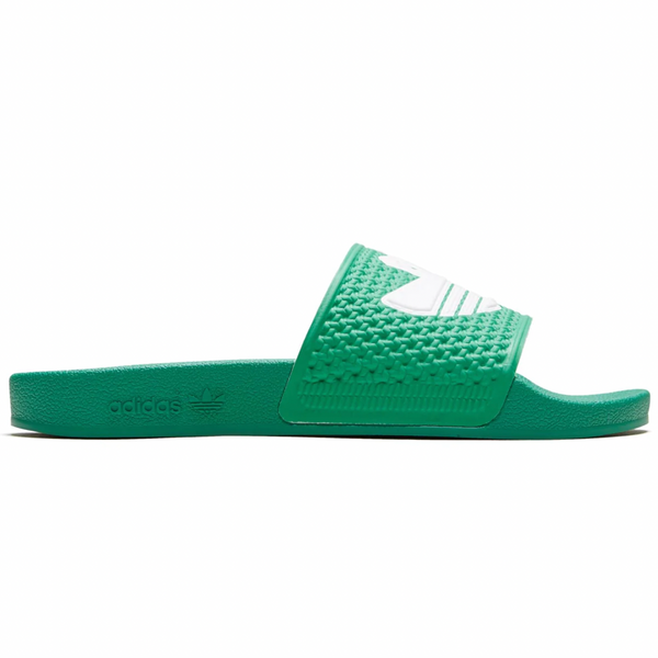 A pair of ADIDAS SHMOOFOIL SEMI COURT GREEN / WHITE slides on a white surface.