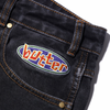 A patch on the back of a pair of Butter Goods Scattered Denim Pants Dark Indigo jeans.