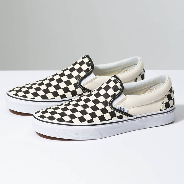 A pair of VANS CLASSIC SLIP-ON BLACK / WHITE CHECKERBOARD slip ons.