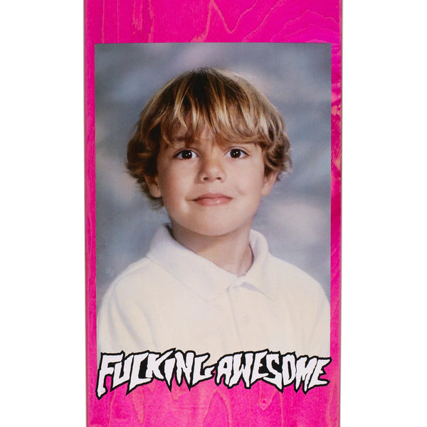 A photo of a young boy with a FUCKING AWESOME CAPLES CLASS PHOTO board featuring various stains, endorsed by Curren Caples.