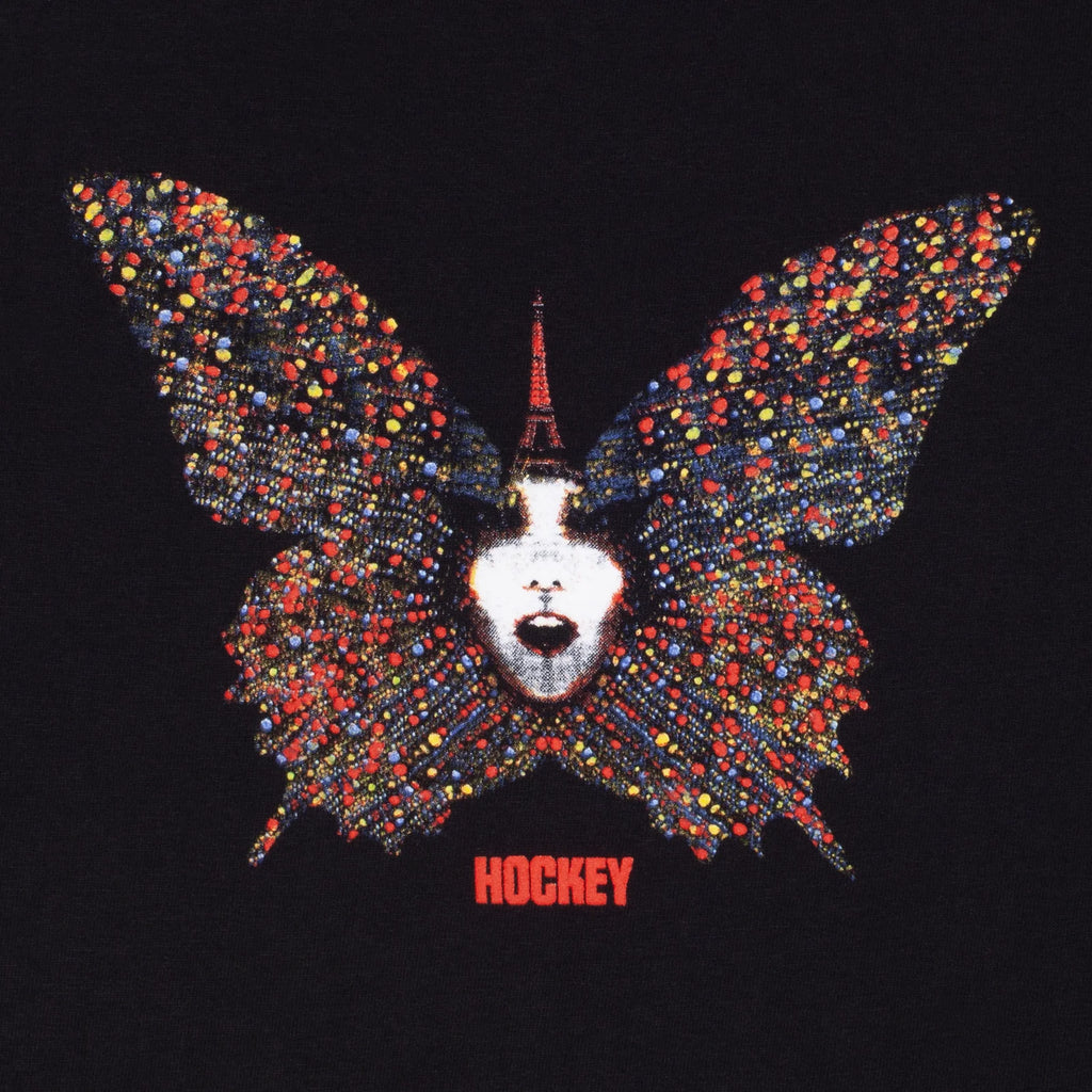 A close up of the butterfly deisgn with a face in the middle and the word "hockey" underneath it.