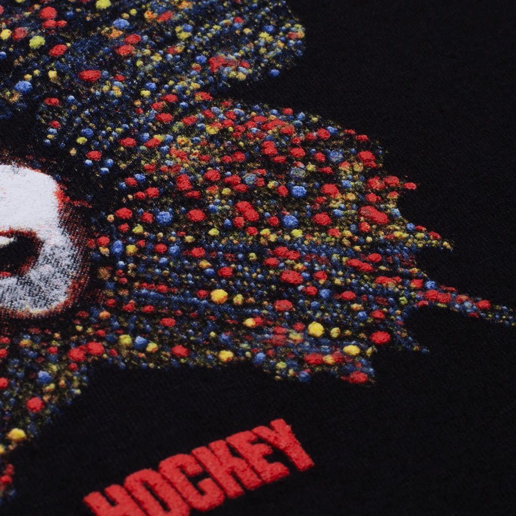 A close up of the raised puff print on the black tee.