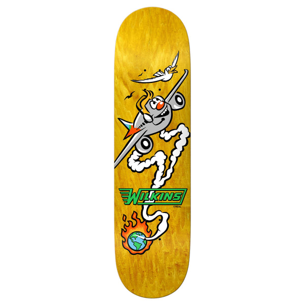 The REAL WILKINS MASCOT skateboard deck by REAL is yellow, 8.5 inches, and features a cartoon airplane with a smiling face, a bird, the number 47, "WILKINS," and a flaming Earth—ideal for any Wilkins Mascot fan.