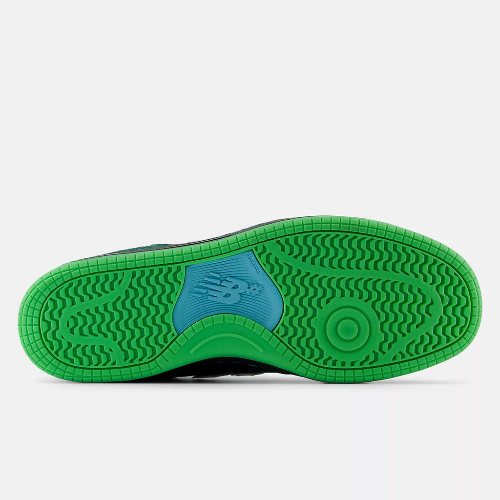 Bottom view of a NB NUMERIC high-top heritage sneaker featuring a green and light blue rubber sole with the "NB" logo in the center. The tread pattern includes zig-zags and circular designs for grip, perfect for life on and off the board. The product showcased is the NB NUMERIC X NATAS KAUPAS 480 HIGH BLACK / LIME GREEN.