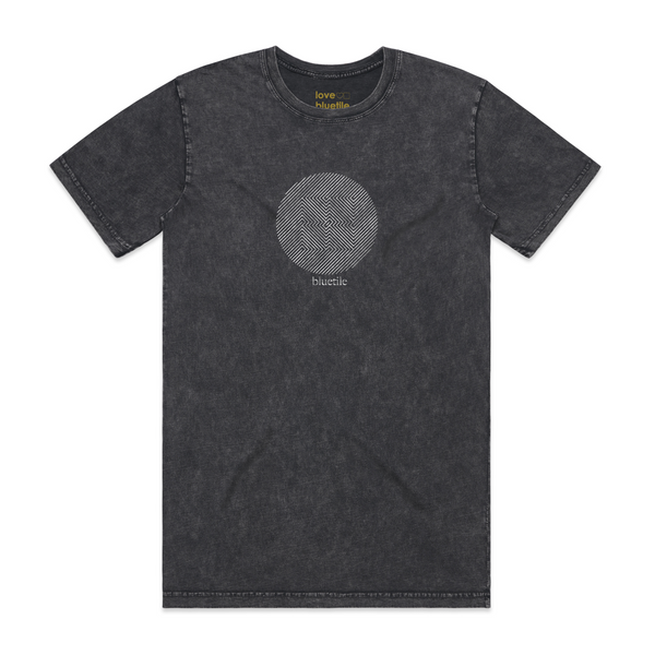 A faded dyed black tee with a geometric image of squares inside of a circle adn "bluetile".