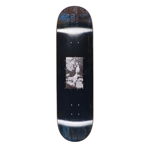 A LIMOSINE skateboard with a black and white image on it.