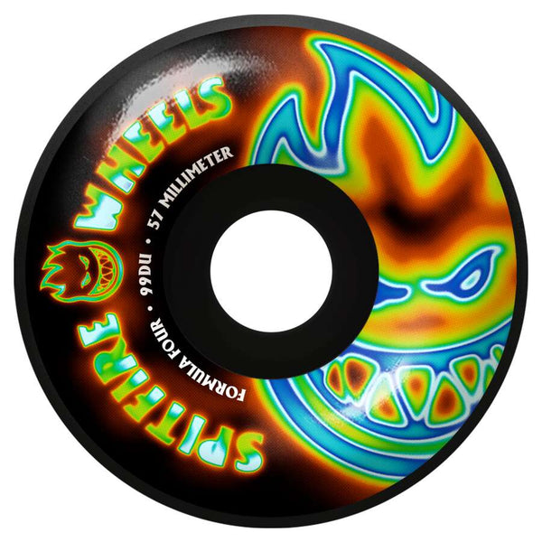 The SPITFIRE F4 RADIOACTIVE CLASSIC BIG HEADS 99D 57MM BLACK skateboard wheel features a black design with a colorful flaming face graphic and "SPITFIRE WHEELS FORMULA FOUR" text.
