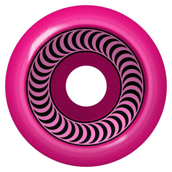 A pink SPITFIRE O.G. CLASSICS 99A 53MM skateboard wheel featuring a central hole, black spiral inner pattern, and branded with O.G. CLASSICS 99A 53MM.