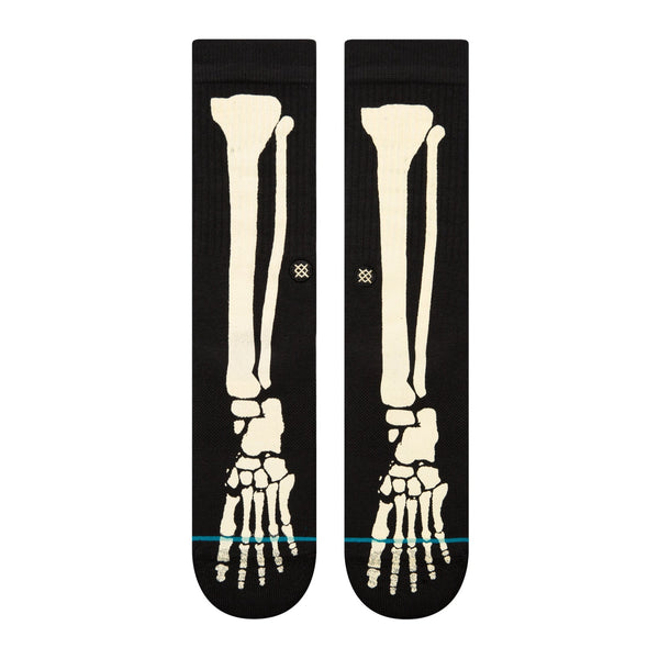 A pair of black STANCE SOCKS BONEZ BLACK LARGE with a skeleton on them.