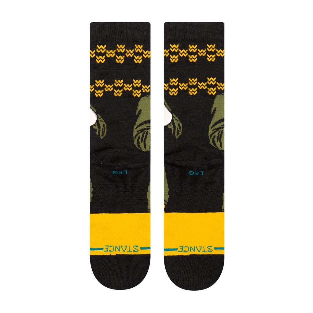 A pair of STANCE socks with a yellow stripe.