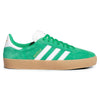 A side-view display of the Adidas Gazelle ADV in green, cloud white, and gold metallic, featuring water-repellent suede, iconic white stripes, and a gum sole.