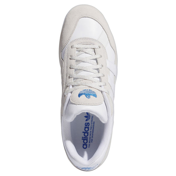 The top view of the white shoe with suede and leather paneling and a blue gonz logo on the tongue. 