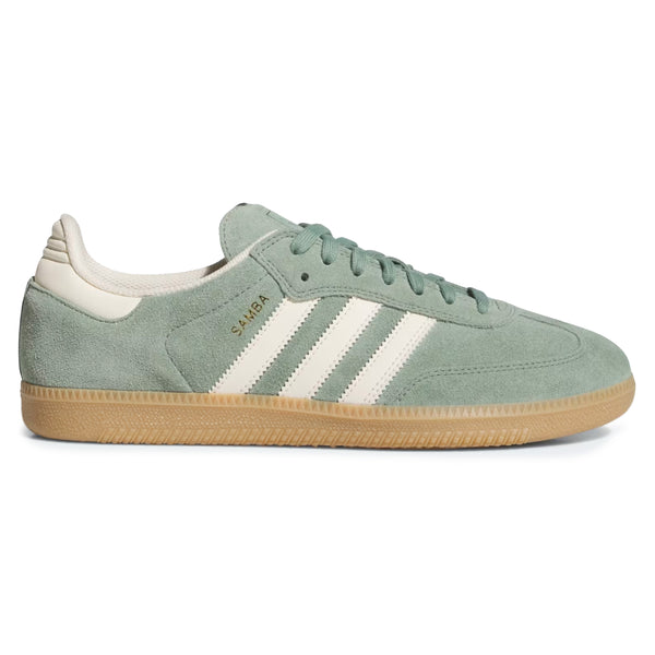 Introducing the ADIDAS SAMBA ADV SILVER GREEN / WONDER WHITE, a skateboarding shoe featuring a green suede design with white stripes, beige accents, and a light brown rubber sole. The word "SAMBA" is elegantly printed in gold on the side. These Samba ADV Shoes boast Adituff toe reinforcement for enhanced durability.