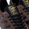 A pair of ADIDAS SAMBA ADV X KADER sneakers in black and gold.