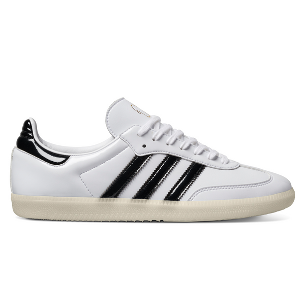 A white and black Adidas Dill Samba Patent sneaker with lace closure.