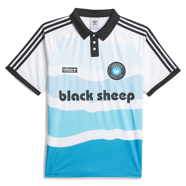 The ADIDAS SKATEBOARDING X BLACK SHEEP X CFC THREE STRIPES POLO is a light blue and white striped short-sleeve shirt featuring "black sheep" text, a "Charlotte FC" logo on the front, and moisture-managing AEROREADY technology.