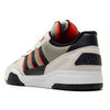 A rear close-up of the ADIDAS TEKKIRA CUP in Orbit Grey, Core Black, and Solar Red shows the Adidas logo on the heel and a durable cupsole, perfect for skateboarding.