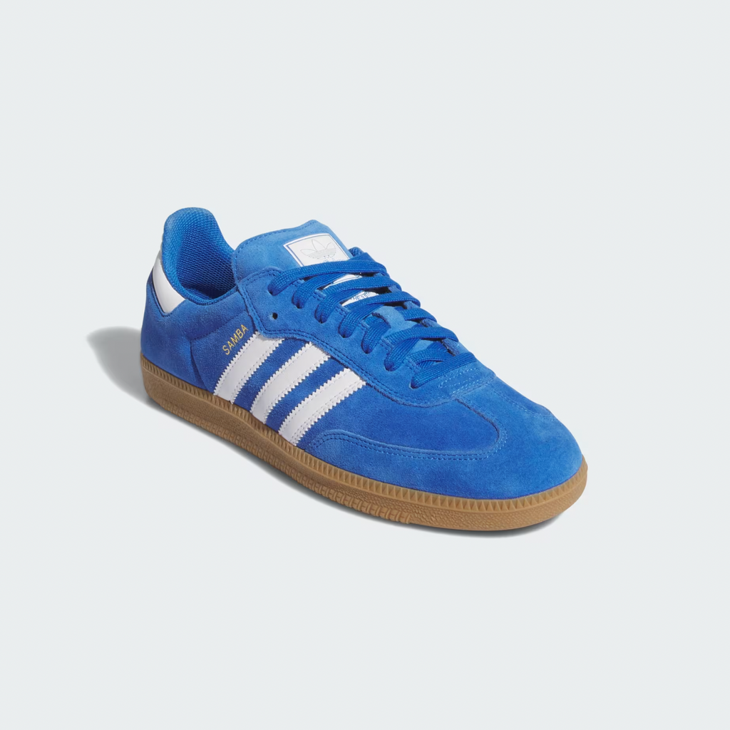 The ADIDAS SAMBA ADV in Blue Bird/Cloud White features a suede upper with Adituff toe reinforcement, white stripes, a brown rubber cupsole, and "Samba" in gold metallic for elegance.