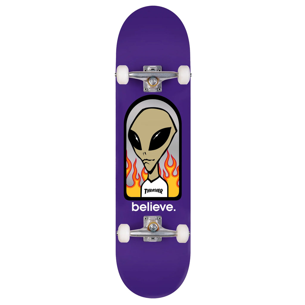 A purple ALIEN WORKSHOP X TRASHER BELIEVE COMPLETE skateboard with a picture of an alien on it.