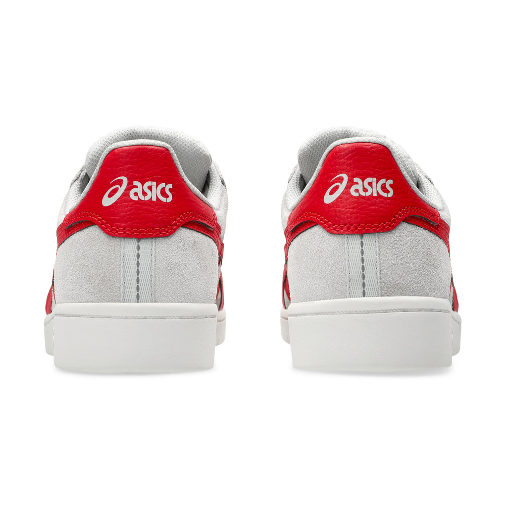 Back view of a pair of ASICS JAPAN PRO CLOUD GREY / CLASSIC RED sneakers, showcasing the heel area with suede paneling and the iconic ASICS logo.