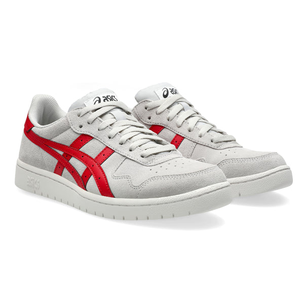 A pair of light gray and white sneakers featuring red accents, with subtle suede paneling and the classic ASICS logo, designed as a versatile skateboarding shoe.